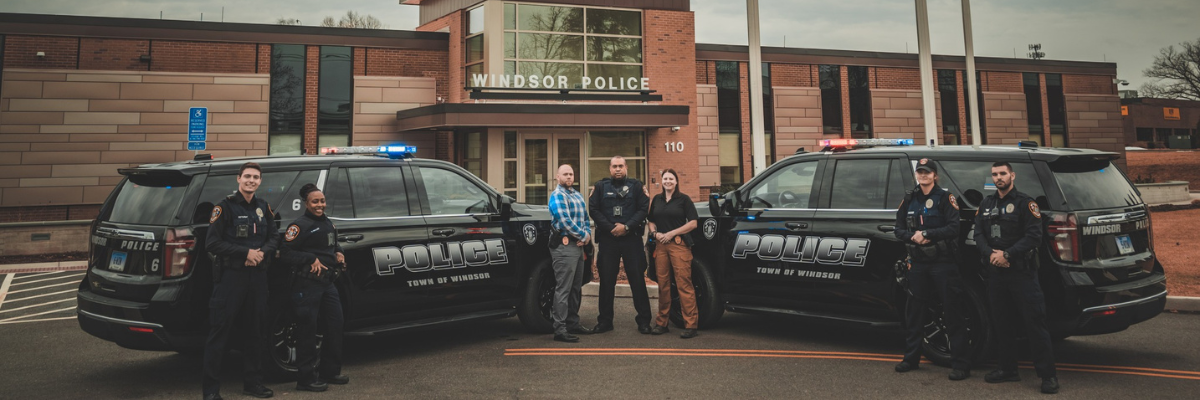 Front of Windsor PD 2 Cruisers and Officers